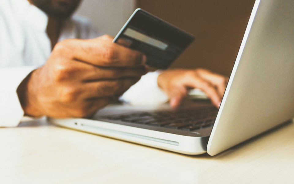 Shopping online on a laptop with a payment card