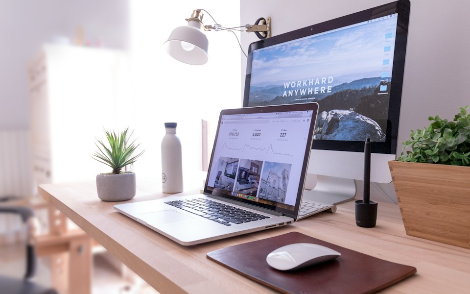 Laptop and monitor displaying web content on a desk