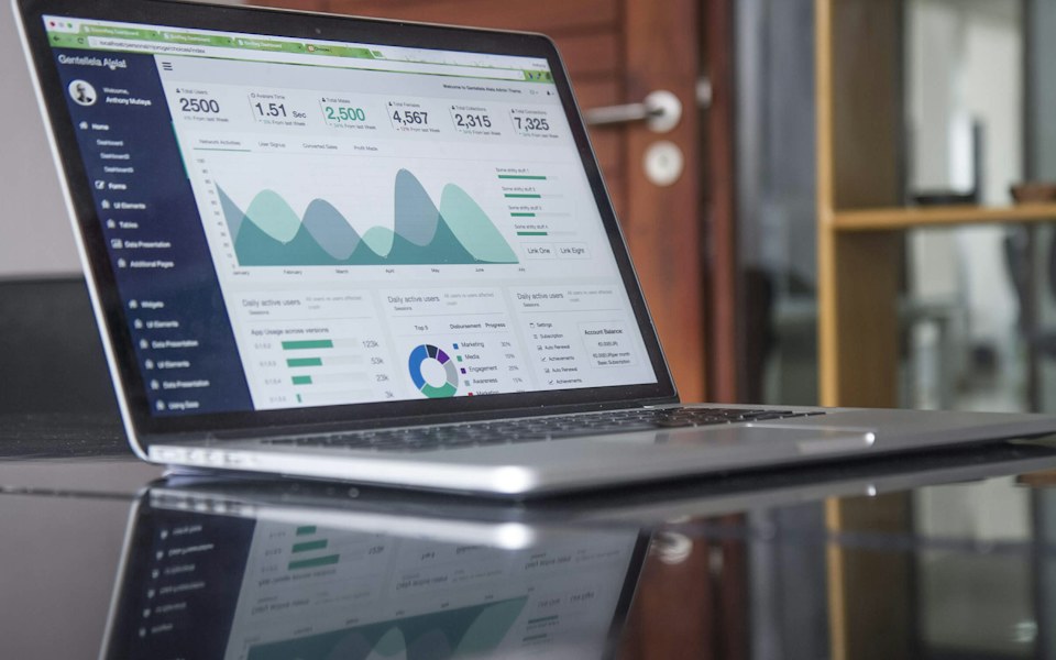 Laptop showing data and charts in a web application